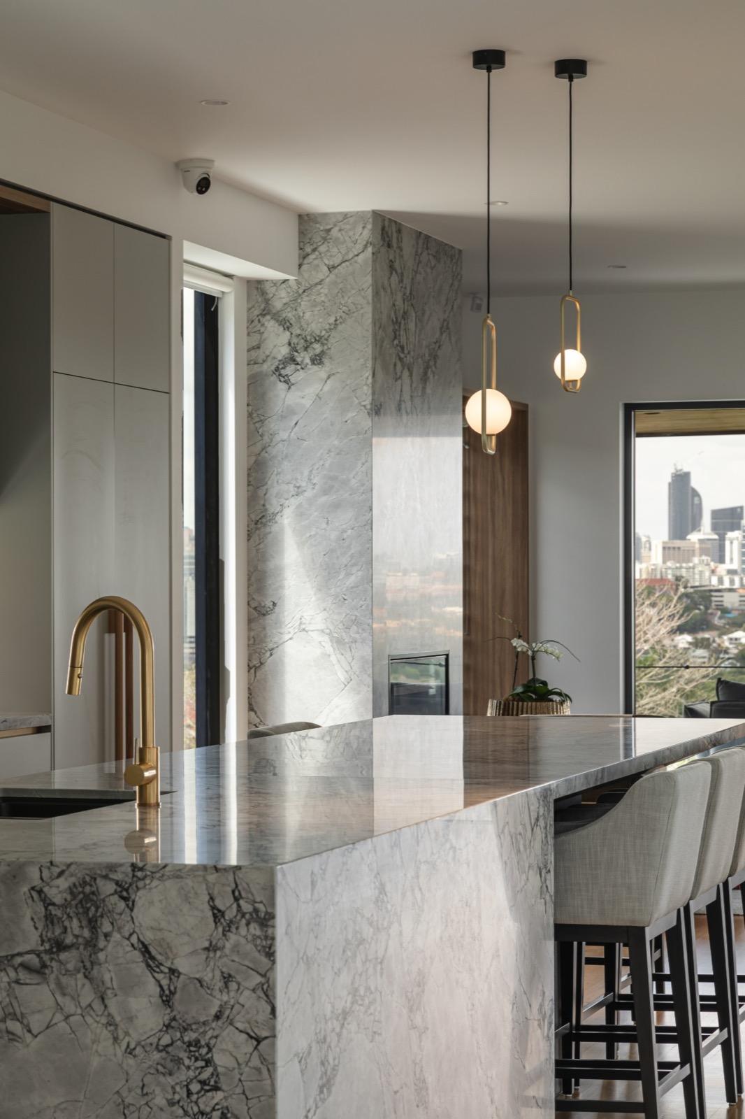 The marriage of classic marble and brass fixtures defines the heart of the home.