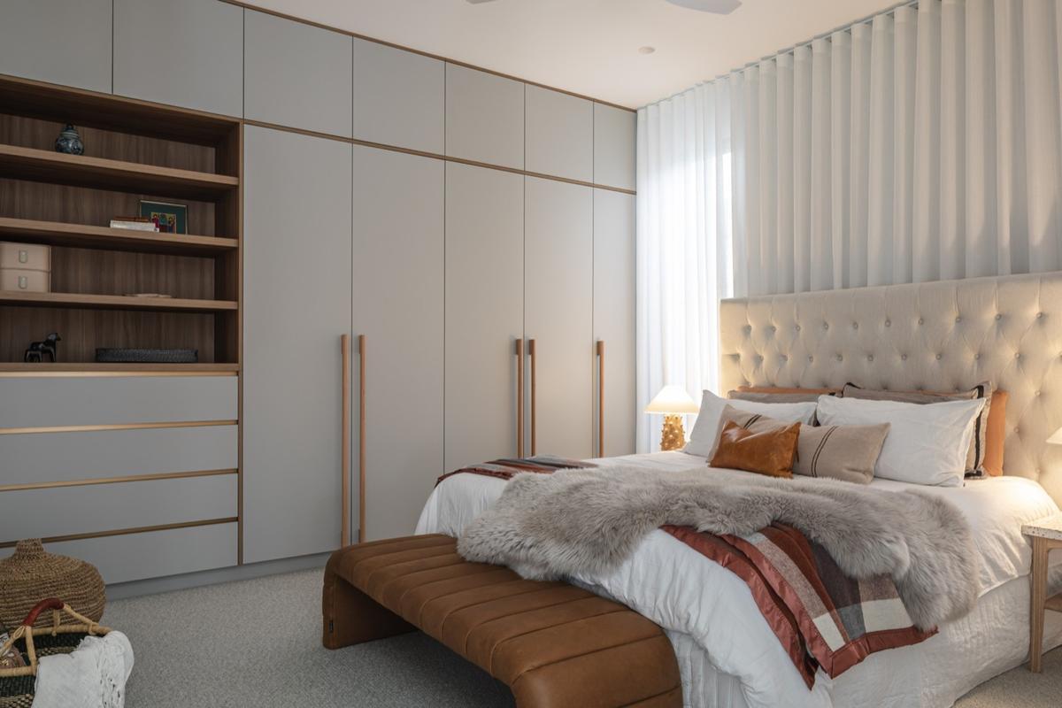 Soft furnishings and minimalist cabinetry reflect a hotel-like luxury in the master suite.